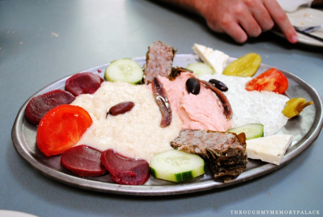 Greek Antipasto - 'platter of sageki, melitzanosalata, scordalia, tomatoes, Greek olives, feta cheese, beets, stuffed grape leaves, and anchovies'
